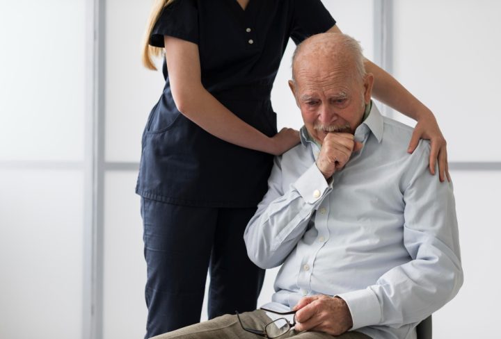 nurse-consoling-old-crying-man